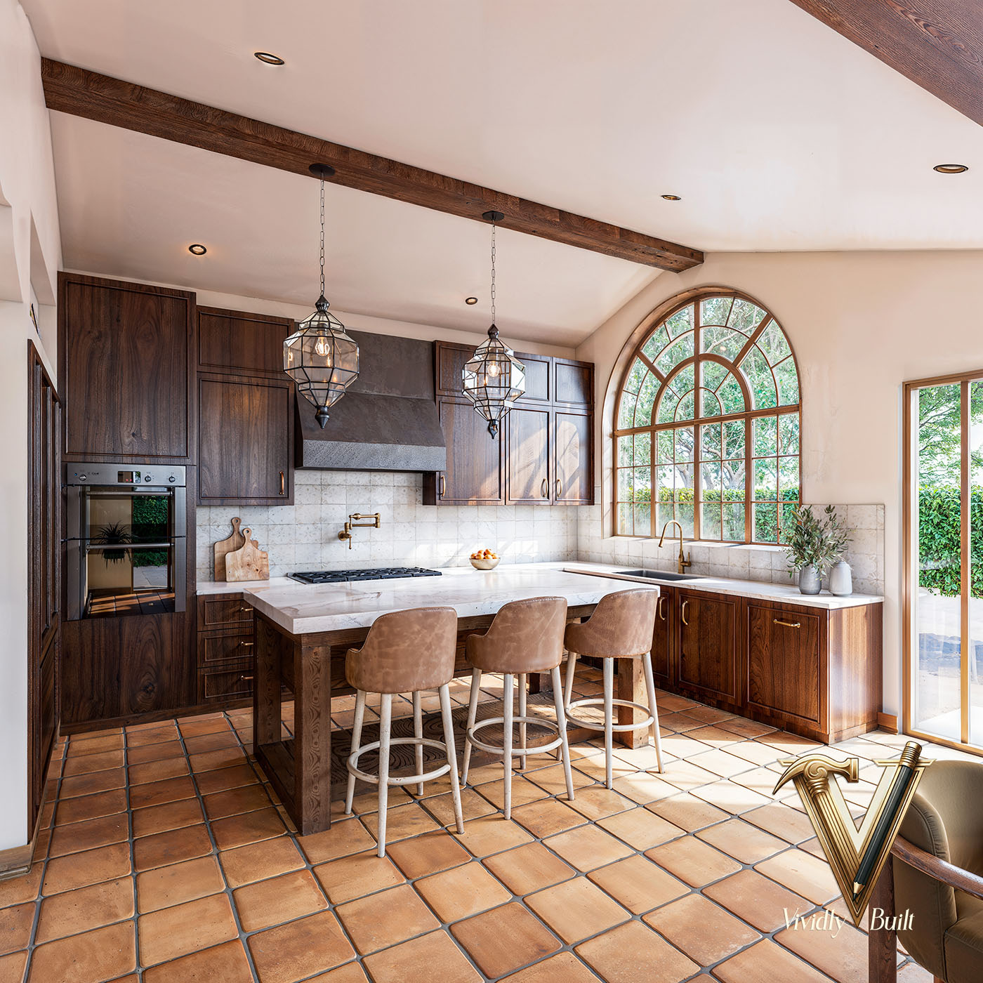 Mediterranean kitchen with arched window, walnut cabinetry, wrought-iron pendants, and terra cotta floors — Mediterranean Estate, Pasadena