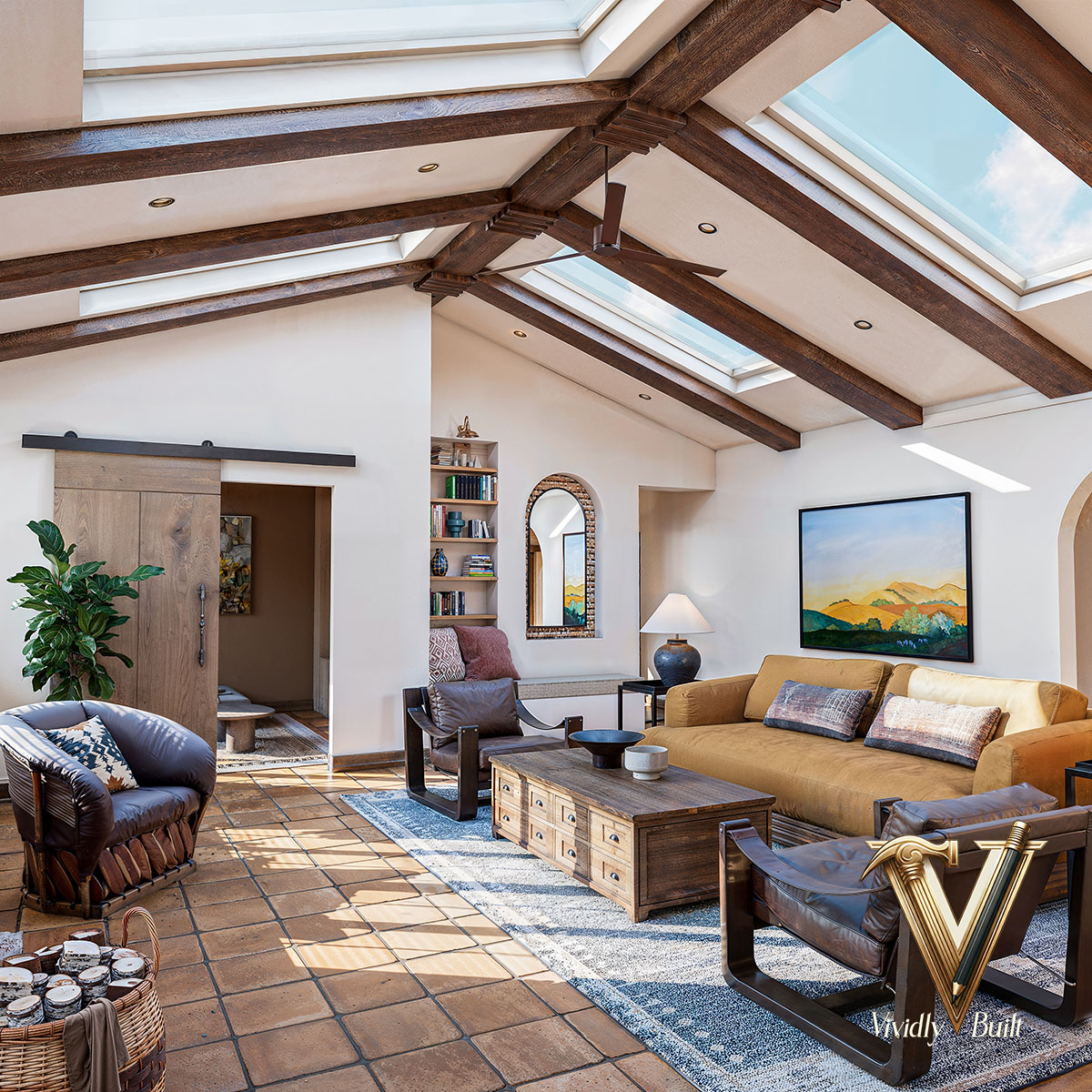 Vaulted-ceiling Mediterranean living room with exposed wood beams, skylights, and terra cotta floors — Mediterranean Estate, Pasadena