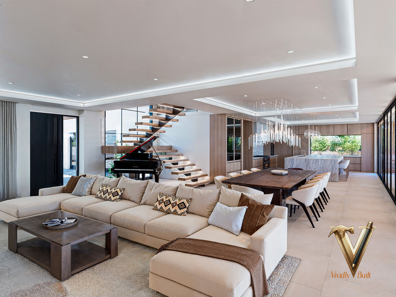 Open living and dining volume with floating oak staircase, grand piano, linear crystal chandelier and walnut table — Modern Estate, Palos Verdes